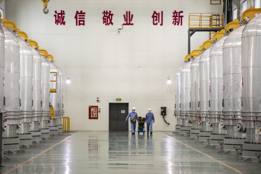 Employees walk past chemical vapour deposition chambers at the Daqo New Energy Corp. plant in Shihezi, Xinjiang province, China, 11 May 2021. (Qilai Shen/Bloomberg)