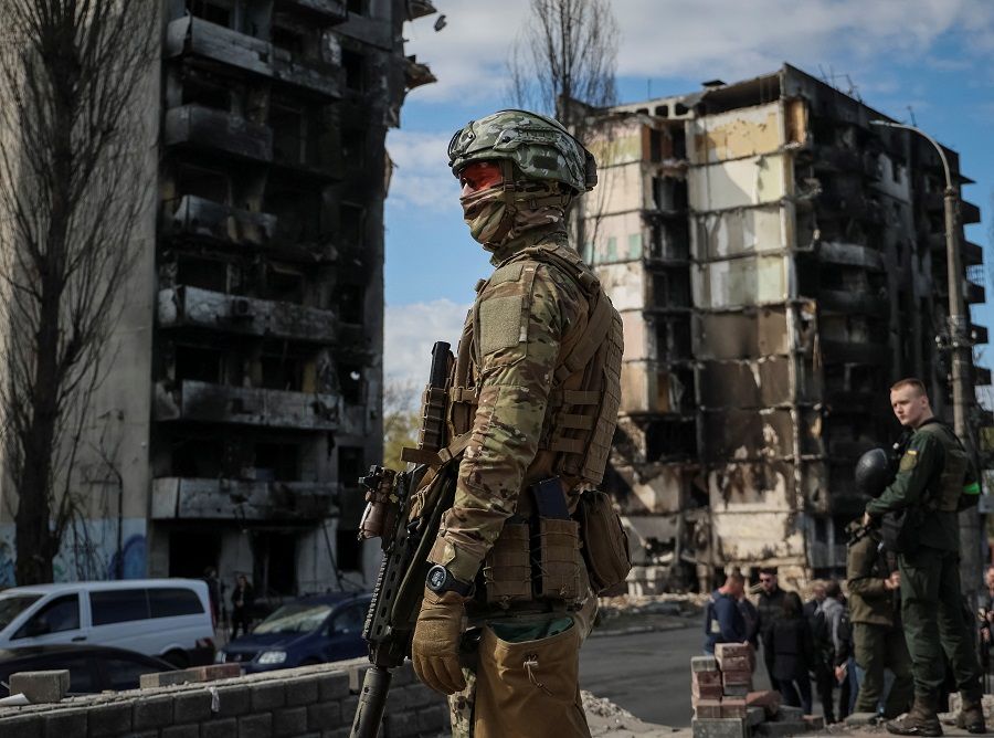 A Ukrainian serviceman stands near buildings destroyed by Russian shelling, as Russia's attack on Ukraine continues, in the town of Borodianka outside of Kyiv, Ukraine, 28 April 2022. (Gleb Garanich/Reuters)
