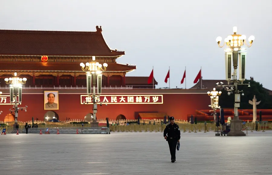 A police officer walks in Tiananmen Square with Tiananmen Gate in the background during the National Day reception on the eve of the 76th founding anniversary of the People's Republic of China, in Beijing, China, 30 September 2025. (Maxim Shemetov/Reuters)