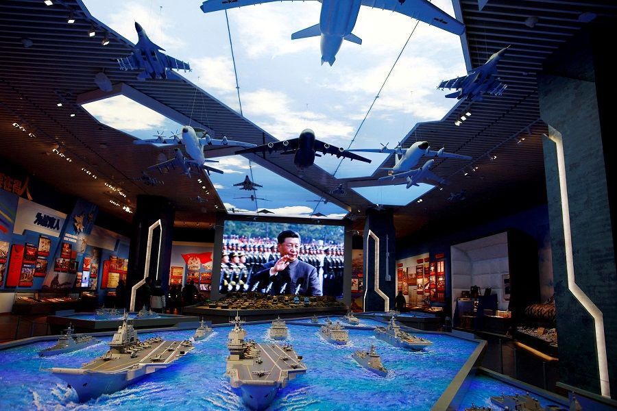Models of military equipment and a giant screen displaying Chinese President Xi Jinping are seen at an exhibition at the Military Museum of the Chinese People's Revolution in Beijing, China 8 October 2022. (Florence Lo/Reuters)