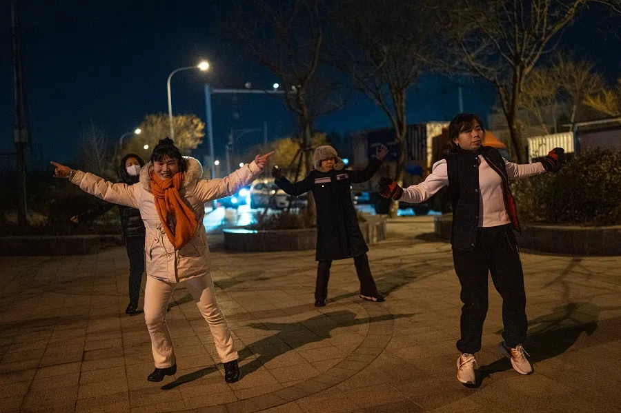 Sister Chen joins a square dance at the village entrance.