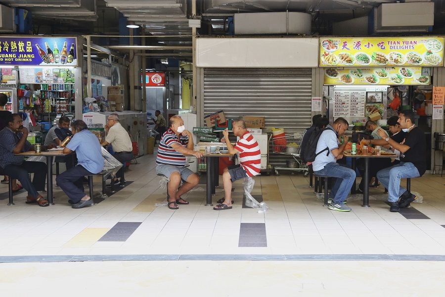 People enjoying hawker fare at a hawker centre in Singapore. (SPH)