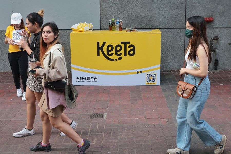 People walk past a KeeTa advertisement in Mong Kok, Hong Kong, 22 May 2023. (HKCNA)