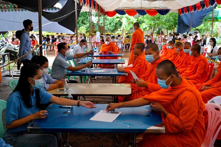 Buddhist monks register to receive the Sinovac Covid-19 coronavirus vaccine at a health centre in Phnom Penh, Cambodia, on 29 August 2021. (Tang Chhin Sothy/AFP)