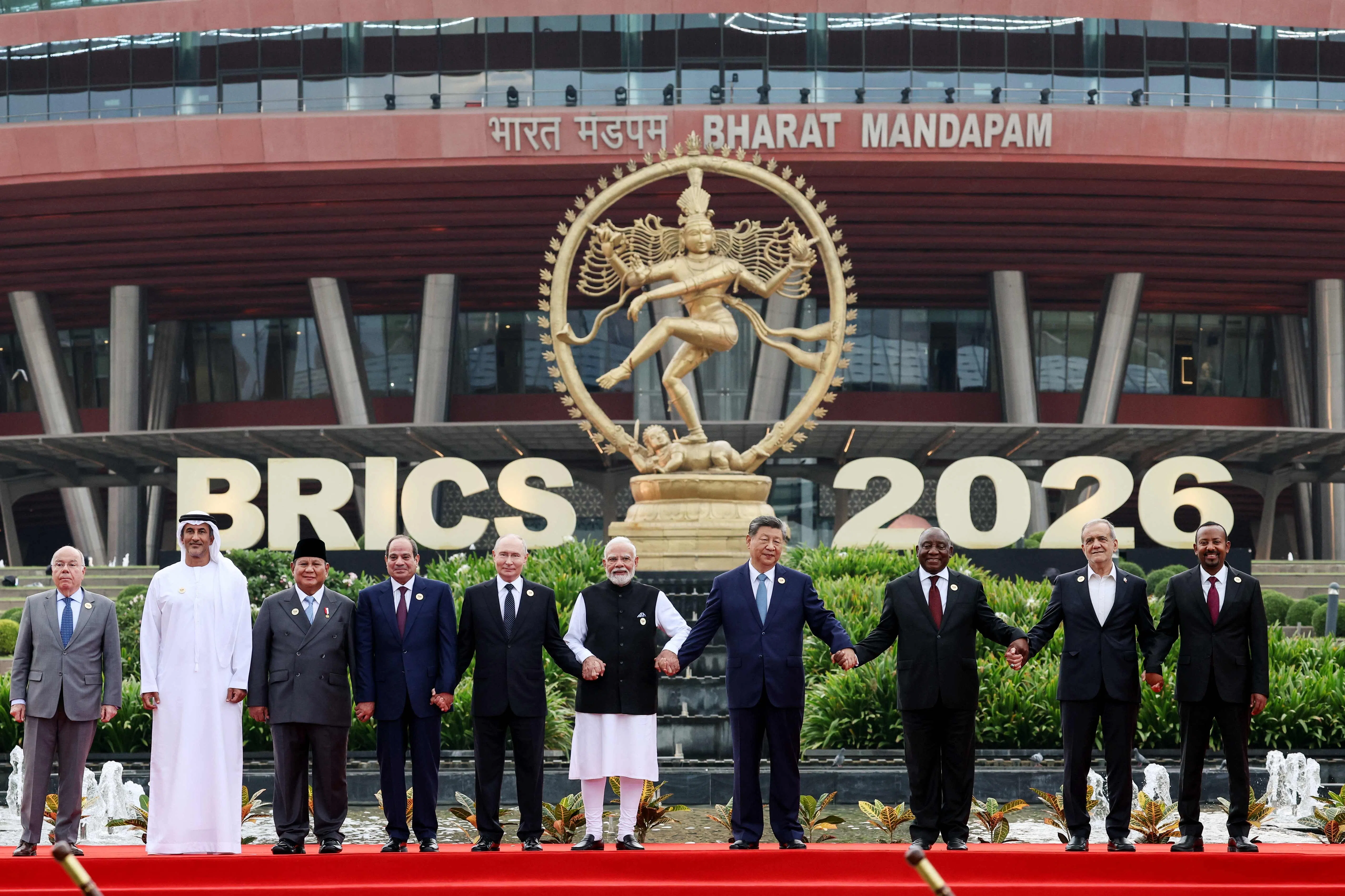 In this pool photograph distributed by the Russian state agency Sputnik, (left to right) Brazil's Foreign Minister Mauro Vieira, UAE's Supreme Council for National Security Secretary-General Ali Mohammed Hammad Al Shamsi, Indonesia's President Prabowo Subianto, Egypt's President Abdel Fattah El-Sisi, Russia's President Vladimir Putin, India's Prime Minister Narendra Modi, China's President Xi Jinping, South Africa's President Cyril Ramaphosa, Iran's President Masoud Pezeshkian and Ethiopia's Prime Minister Abiy Ahmed pose for a family photo during the 18th BRICS Summit in New Delhi.