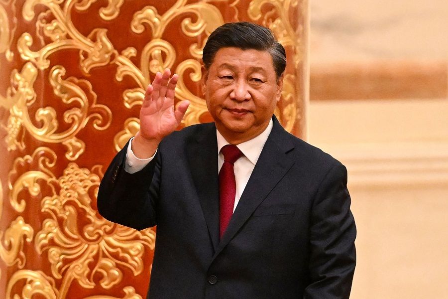 Chinese President Xi Jinping waves as he walks with members of the Chinese Communist Party's new Politburo Standing Committee, the nation's top decision-making body, to meet the media in the Great Hall of the People in Beijing, China, on 23 October 2022. (Noel Celis/AFP)