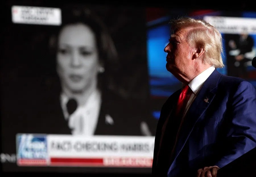 Republican presidential nominee, former US President Donald Trump, watches a video of Vice-President Kamala Harris during a campaign rally at The Expo at World Market Center Las Vegas on 13 September 2024 in Las Vegas, Nevada.