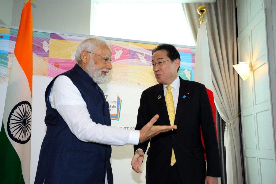 India's Prime Minister Narendra Modi (left) chats with Japan's Prime Minister Fumio Kishida (right) during their bilateral meeting on the sidelines of the G7 Summit Leaders' Meeting in Hiroshima on 20 May 2023. (Japan Pool/Jiji Press/AFP)