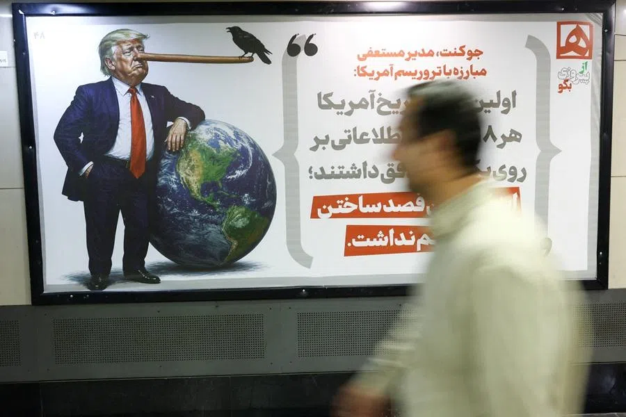 People walk past a caricature depicting US President Donald Trump, in Tehran, Iran, 4 May 2026.
