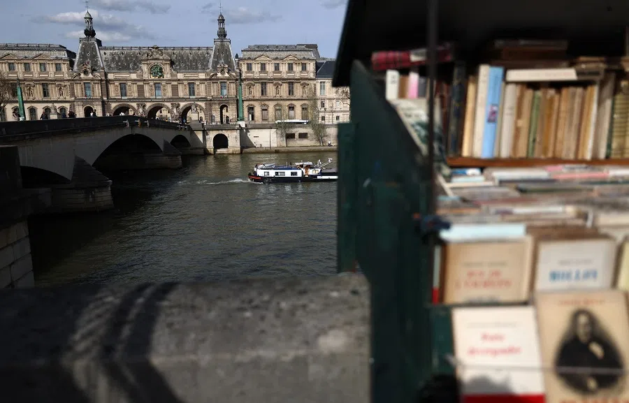 A boat cruises along the Seine river past the Louvre Museum in central Paris, France, on 20 March 2024. (Emmanuel Dunand/AFP)