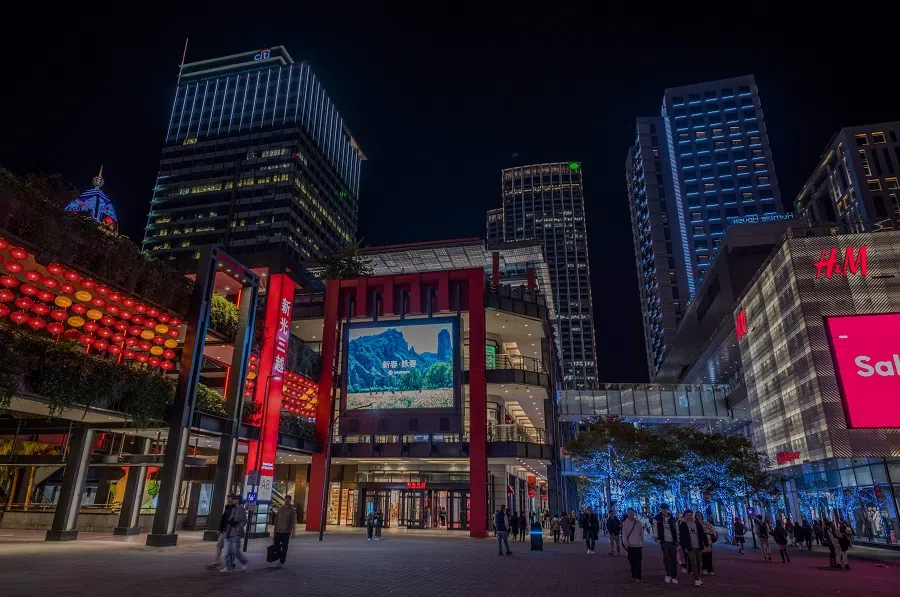 People walk among the department stores at the Xinyi district in Taipei on 16 January 2024. (Sam Yeh/AFP)