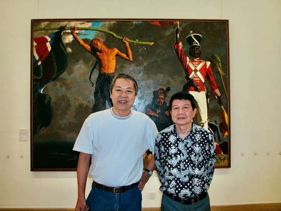 The author (left) with artist Siew Hock Meng, against the latter’s work The Dawn of an Era, Beijing, 2004. (Photo provided by Teo Han Wue)