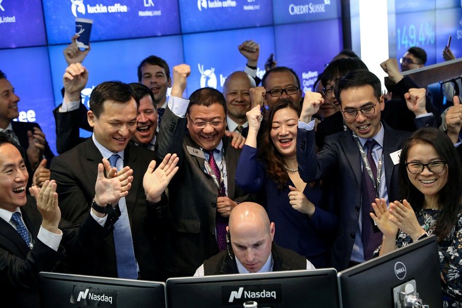 Jenny Qian Zhiya CEO of Luckin Coffee, and Charles Zhengyao Lu, non-executive chairman of Luckin Coffee, celebrate the first trade of the company's stock during the IPO at the Nasdaq Market site in New York, US, on 17 May 2019. (Brendan McDermid/File Photo/Reuters)