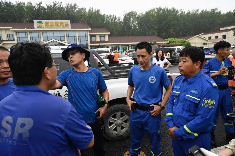 Members of rescue organisation Bluesky rescue team assemble before heading to Zhengzhou, a flood-hit city in central China, in Beijing on 21 July 2021. (Jade Gao/AFP)
