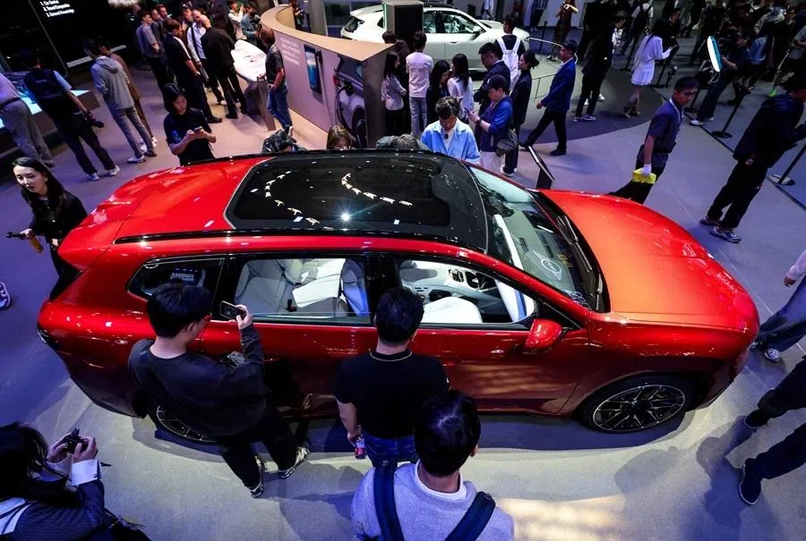 People gather around the BMW iX3 model at the company’s booth at the Beijing International Automotive Exhibition (Auto China), in Beijing, China, on 24 April 2026.