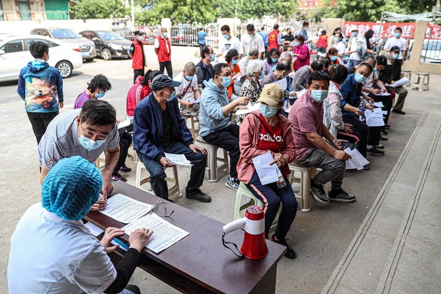 Residents prepare to receive the Anhui Zhifei Longcom Covid-19 coronavirus vaccine in Shenyang, Liaoning province, China on 21 May 2021. (STR/AFP)