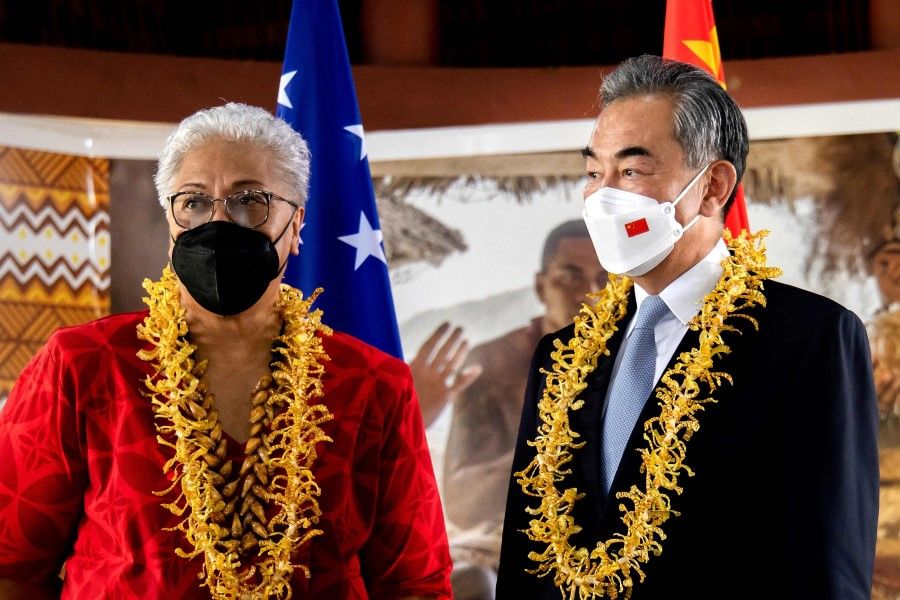 This picture released by the Samoa Observer on 28 May 2022 shows Chinese Foreign Minister Wang Yi (right) and Samoa Prime Minister Fiame Naomi Mataafa attending an agreement signing ceremony between the two countries in Apia. (Vaitogi Asuisui Matafeo/Samoa Observer/AFP)