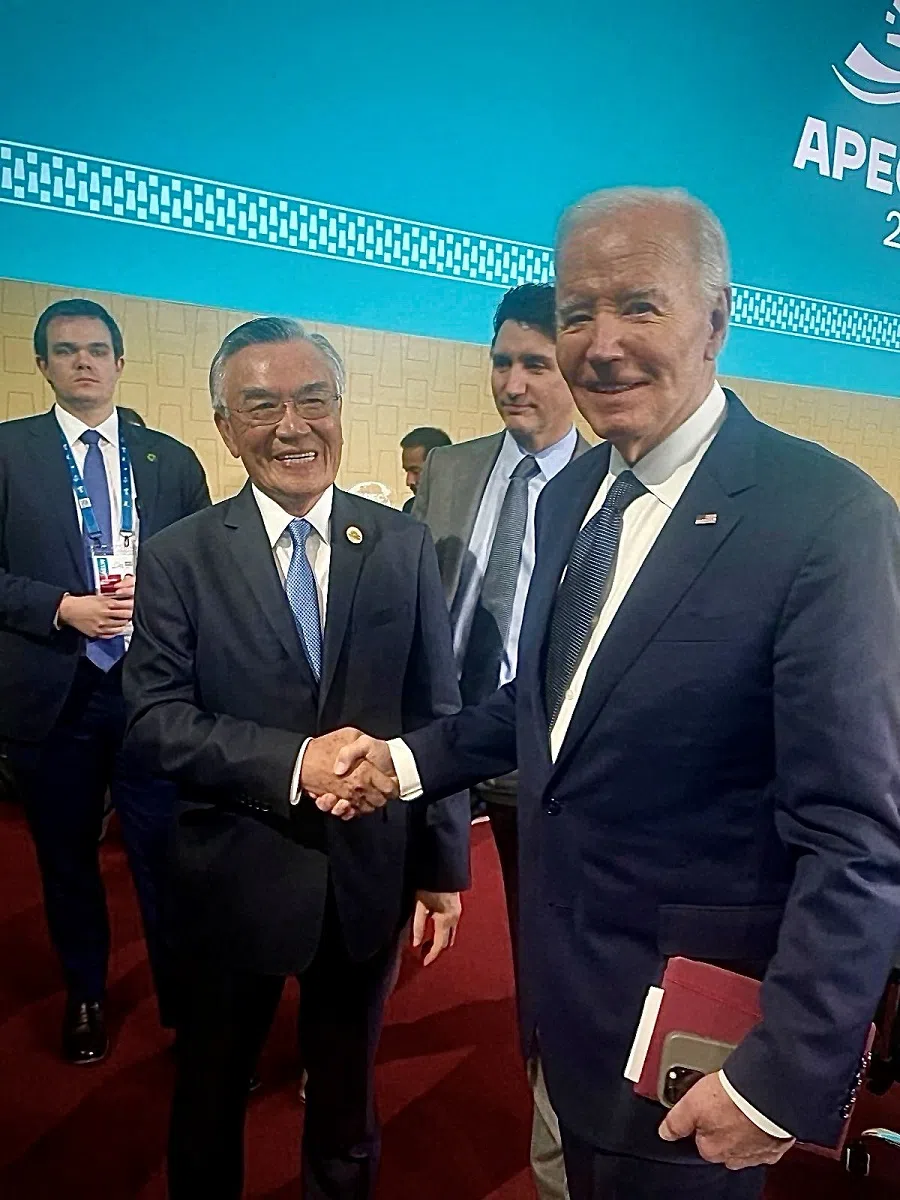 Taiwan’s APEC representative Lin Hsin-i poses for a photo with US President Joe Biden, as Canadian Prime Minister Justin Trudeau stands behind them, at the APEC summit in Lima, Peru, on 15 November 2024. (Taiwan’s APEC delegation/Handout via Reuters)
