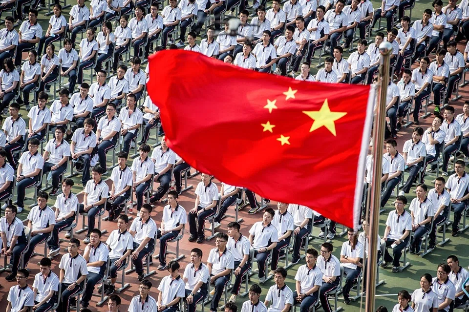 Students attend the 100th anniversary of the founding of Wuhan High School on the first day of the new semester in Wuhan, Hubei, China, on 1 September 2020. (STR/AFP)