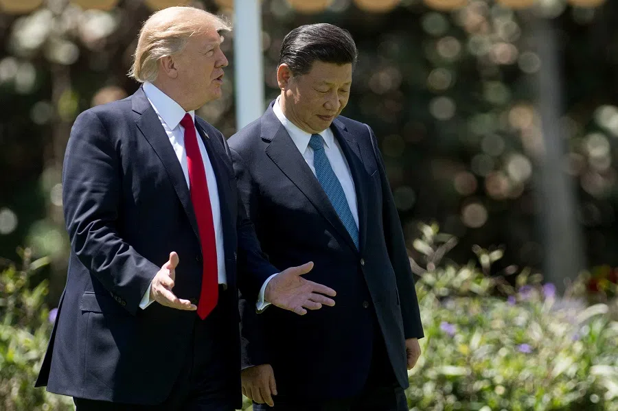 US President Donald Trump (left) and Chinese President Xi Jinping (right) walk together at the Mar-a-Lago estate in Palm Beach, Florida, on 7 April 2017. (Jim Watson/AFP)