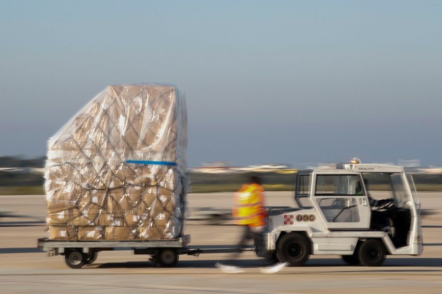 A shipment containing supplies of personal protective equipment is unloaded at Bari airport after arriving from Guangzhou, China, to help the southern Italian region of Puglia combat the spread of Covid-19, on 7 April 2020. (Alessandro Garofalo/Reuters)