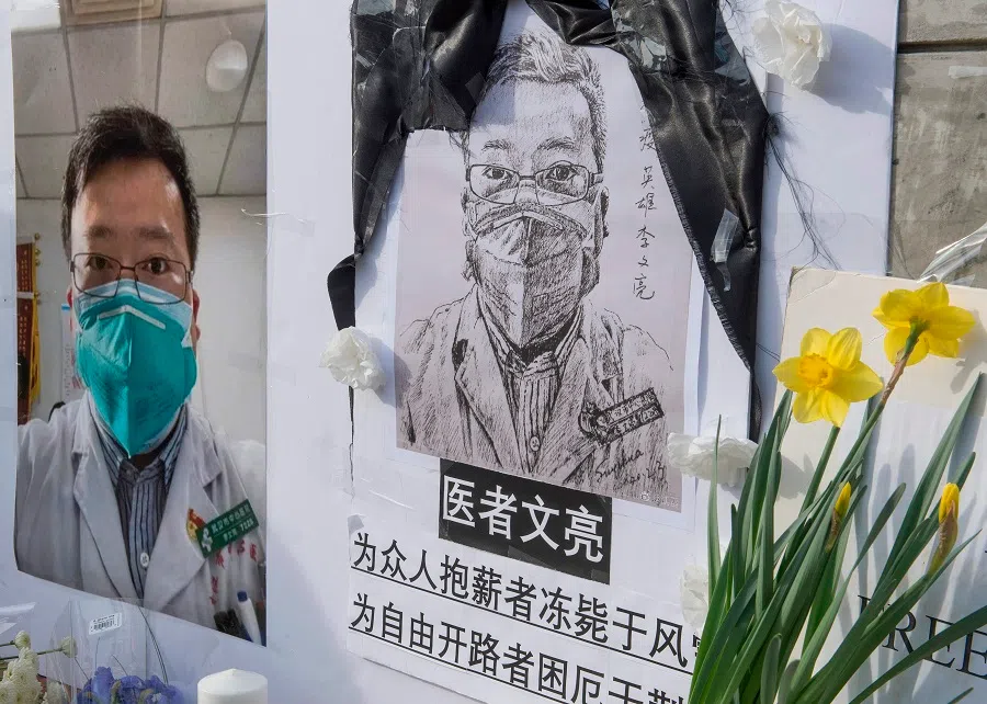 Chinese students and their supporters hold a memorial for Dr Li Wenliang outside the UCLA campus in Westwood, California, on 15 February 2020. (Mark Ralston/AFP)