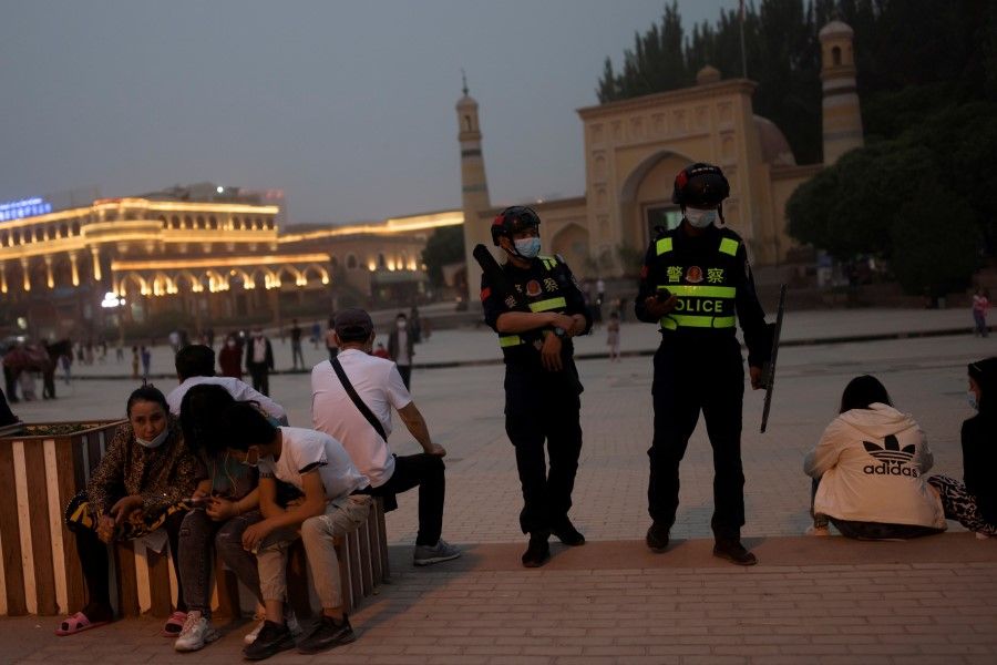 Police officers patrol the square in front of Id Kah Mosque in Kashgar, Xinjiang Uyghur Autonomous Region, China, 3 May 2021. (Thomas Peter/Reuters)