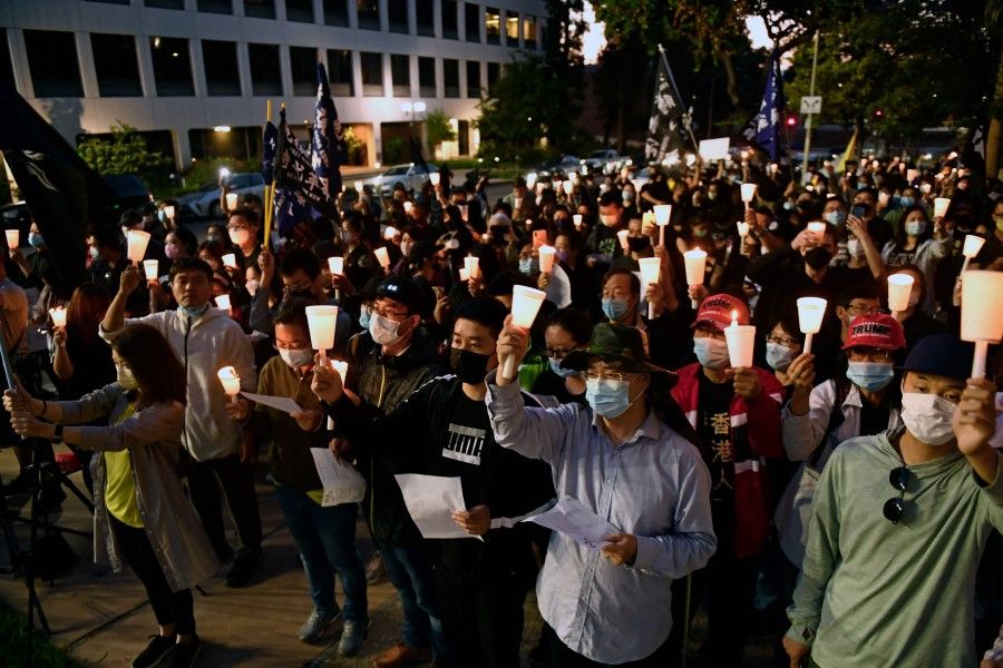 People attend a vigil commemorating the 32nd anniversary of the 1989 Tiananmen square pro-democracy protests and crackdown outside of the Chinese consulate in Los Angeles, California on 4 June 2021. (Patrick T. Fallon/AFP)