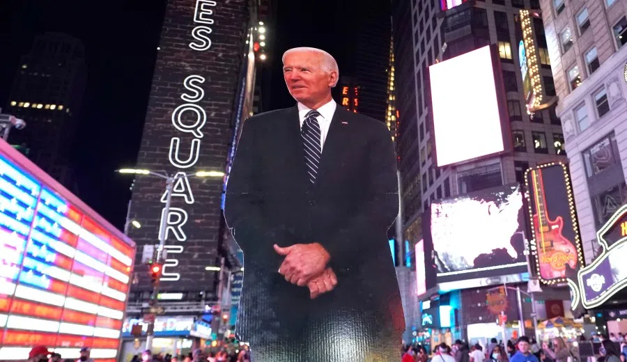 People celebrate at Times Square in New York after Joe Biden was declared winner of the 2020 presidential election on 7 November 2020. (Timothy A. Clary/AFP)