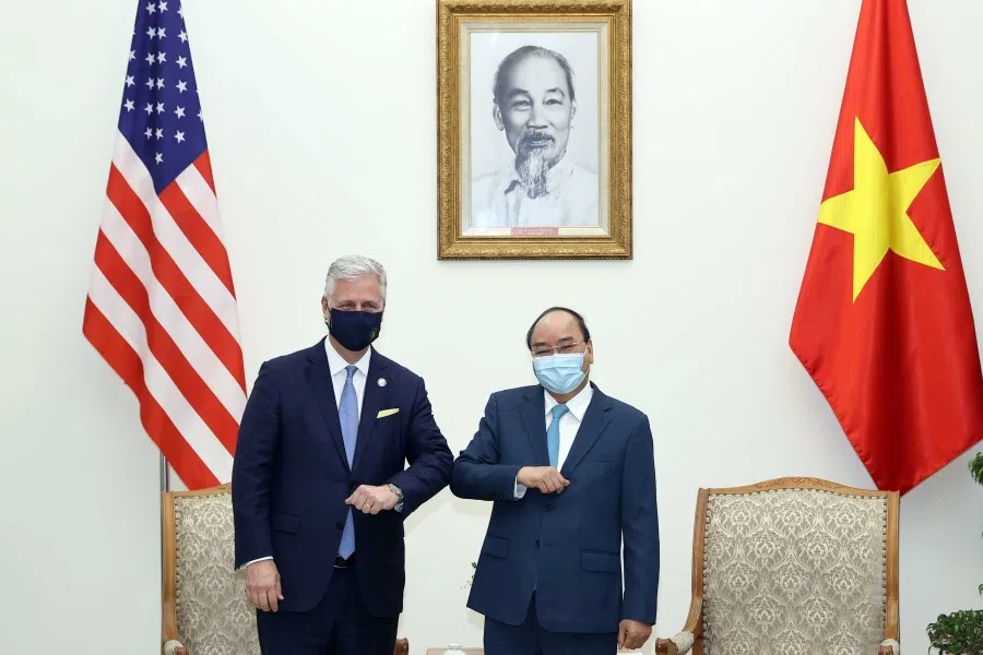 This picture taken and released on 21 November 2020 by the Vietnam News Agency shows Vietnam's Prime Minister Nguyen Xuan Phuc (R) bumping elbows to greet US National Security Advisor Robert O'Brien during a meeting in Hanoi. (Vietnam News Agency/AFP)