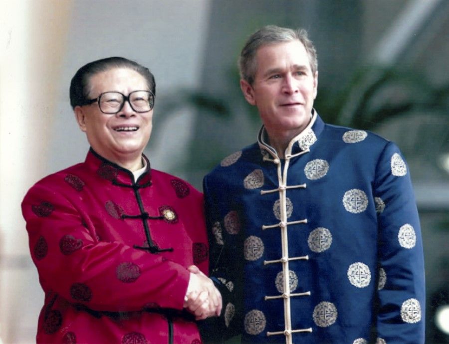 US President George W. Bush attends the 2001 APEC summit held in Beijing and poses for a photo with Chinese President Jiang Zemin wearing traditional Chinese clothing.