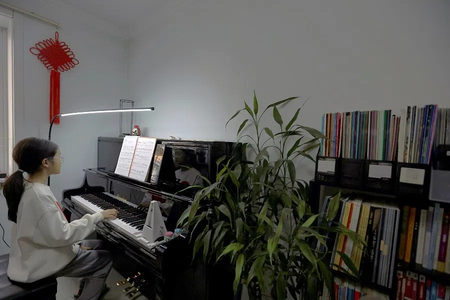 A student attends a piano lesson at a classroom in Beijing, China, on 12 March 2024. (Florence Lo/Reuters)