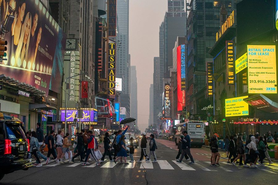 People make their way around Times Square on 7 June 2023 in New York City, US. (Eduardo Munoz Alvarez/Getty Images/AFP)