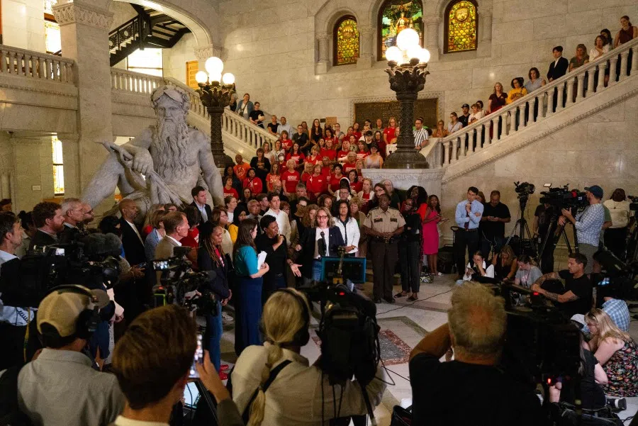 People attend a press conference with city officials and gun legislation advocates following a mass shooting at Annunciation Catholic School on 28 August 2025 in Minneapolis, Minnesota.  (Stephen Maturen/AFP)