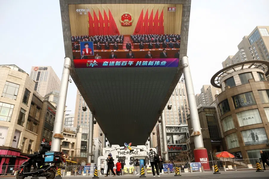 A giant screen shows Chinese President Xi Jinping attending the closing session of the National People's Congress (NPC) at the Great Hall of the People, in Beijing, China, 11 March 2021. (Tingshu Wang/Reuters)