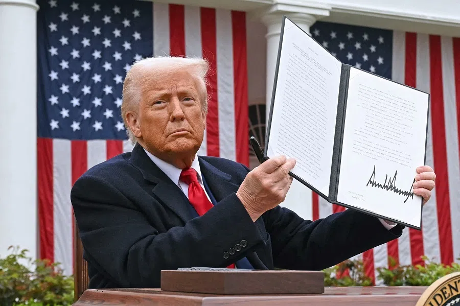 US President Donald Trump holds a signed executive order after delivering remarks on reciprocal tariffs during an event in the Rose Garden entitled “Make America Wealthy Again” at the White House in Washington, DC, US, on 2 April 2025. (Saul Loeb/AFP)