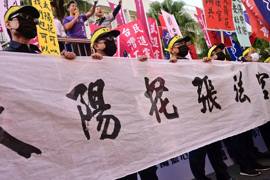 Masked police officers take part in a protest, against a court decision ordering police to pay compensation to a group of protesters who were injured during the "Sunflower Movement" clashes in 2014 over a controversial trade pact with China, outside the Taipei District Court in Taipei, November 2019. (Sam Yeh/AFP)
