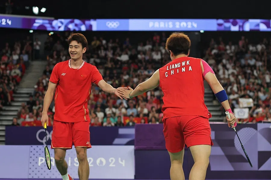Liang Weikeng and Wang Chang (left) of the People’s Republic of China react during the match against Wang Chi-lin and Lee Yang of Chinese Taipei during the Paris 2024 Olympic Games at Porte de la Chapelle Arena in Paris, France, on 4 August 2024. (Ann Wang/Reuters)