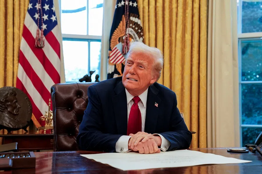 US President Donald Trump signs executive orders in the Oval Office at the White House in Washington, US, on 30 January 2025. (Elizabeth Frantz/Reuters)