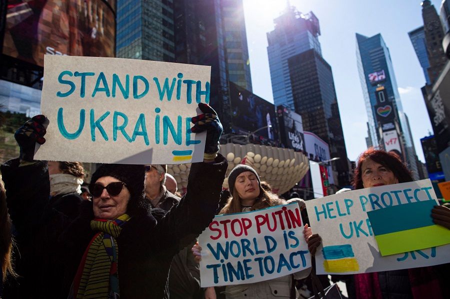 Demonstrators gather in support of Ukraine during a rally in Times Square, New York, US, on 26 February 2022. (Kena Betancur/AFP)
