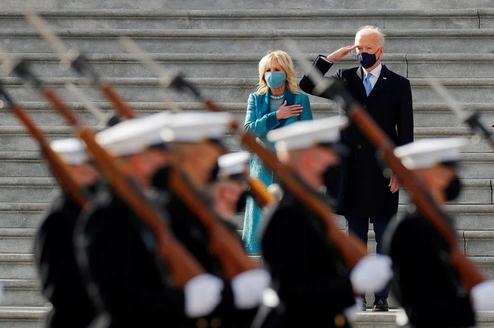 US President Joe Biden salutes as first lady Jill Biden puts her hand over her heart during the pass in review after the inauguration ceremony, in Washington, US, 20 January 2021. (Mike Segar/Reuters)