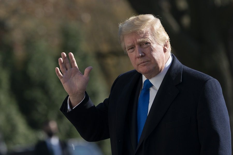 US President Donald Trump waves while walking on the South Lawn of the White House after exiting Marine One in Washington, DC, US, on 29 November 2020. (Chris Kleponis/Bloomberg)