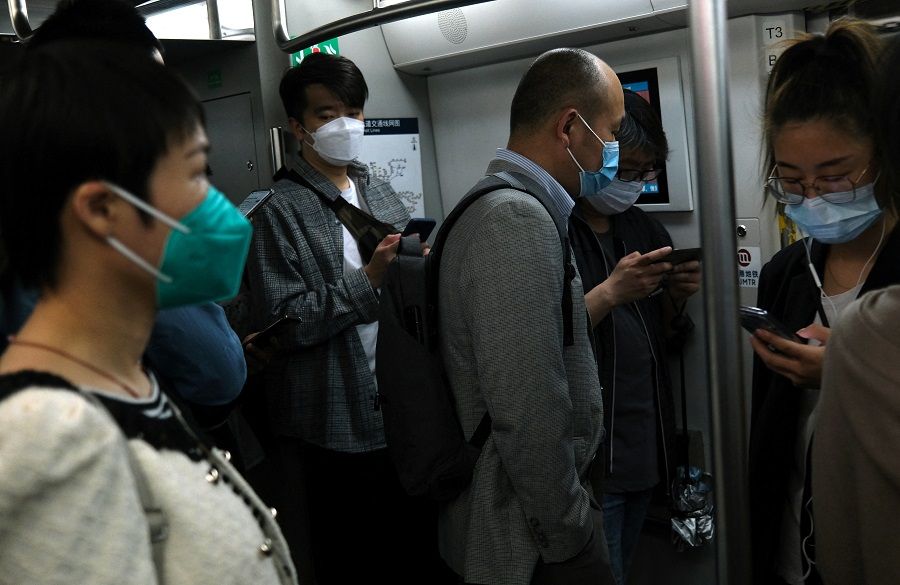People ride on a subway train during morning rush hour amid the Covid-19 outbreak in Beijing, China, 6 May 2022. (Tingshu Wang/Reuters)