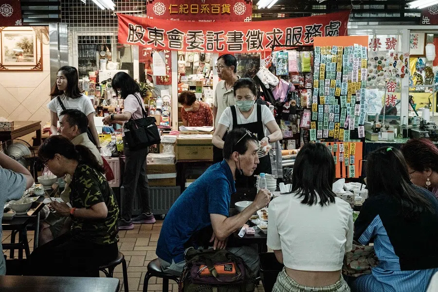 People eat at a market in Taipei, Taiwan, on 26 May 2024. (Yasuyoshi Chiba/AFP)