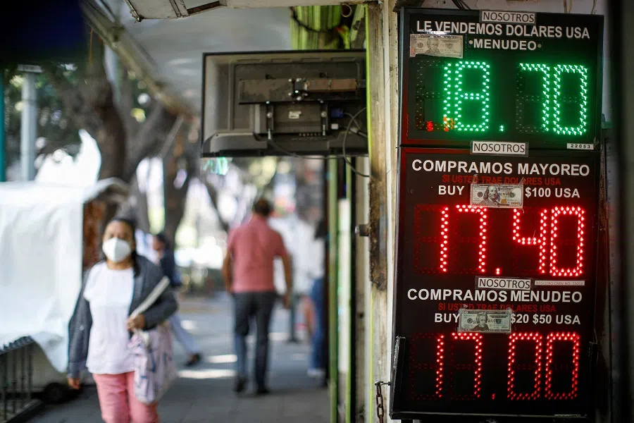 A board displays the exchange rates for Mexican Peso and US Dollar in Mexico City, Mexico, 13 March 2023. (Raquel Cunha/File Photo/Reuters)