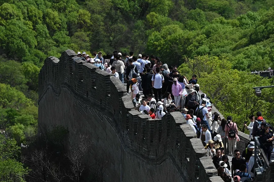 People climb the Great Wall of China at Badaling, north of Beijing, on 1 May 2024.  (Greg Baker/AFP)