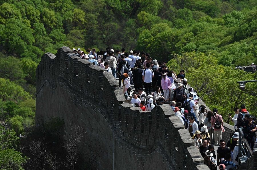 People climb the Great Wall of China at Badaling, north of Beijing, on 1 May 2024.  (Greg Baker/AFP)