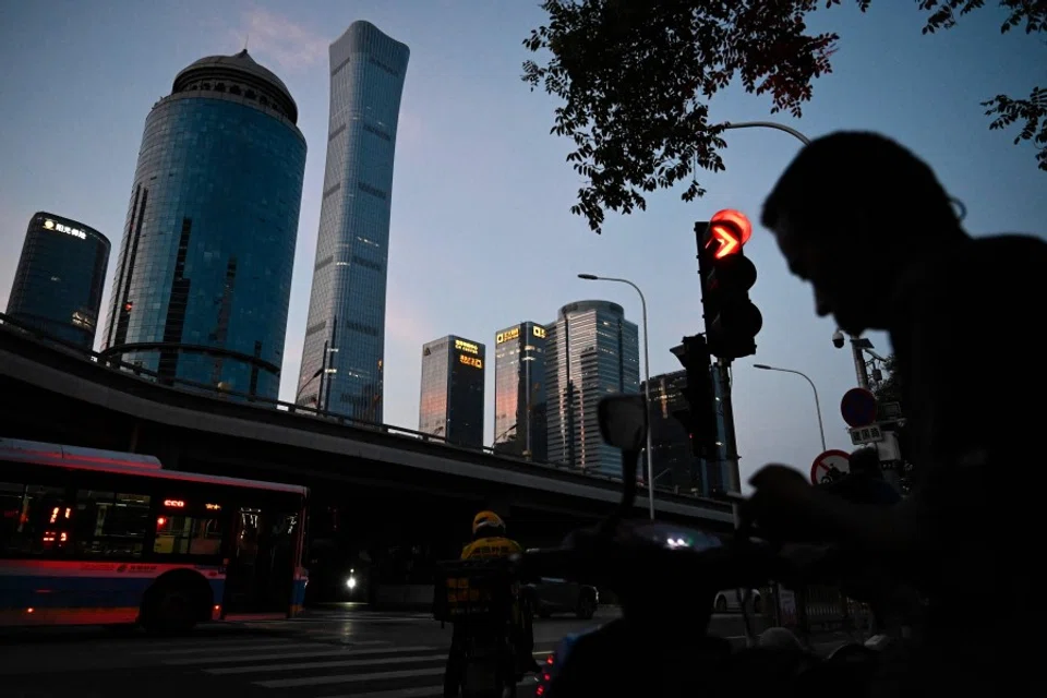 People wait for traffic lights at the central business district in Beijing, China, on 23 July 2023. (Jade Gao/AFP)