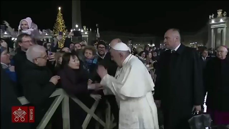 A frame grab taken from a handout video made available by Vatican Media on January 01, 2020 shows Pope Francis slapping his way free from a lady as he greets Catholic faithful prior to celebrating New Year's Eve mass in Vatican City on December 31, 2019. The video clip was widely viewed on social media. Pope Francis apologised the next day. (AFP photo/Vatican Media)