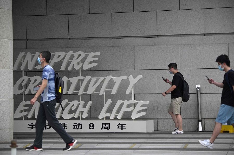 Employees walk outside the headquarters of ByteDance, the owner of video sharing app TikTok, in Beijing on 5 August 2020. (Noel Celis/AFP)